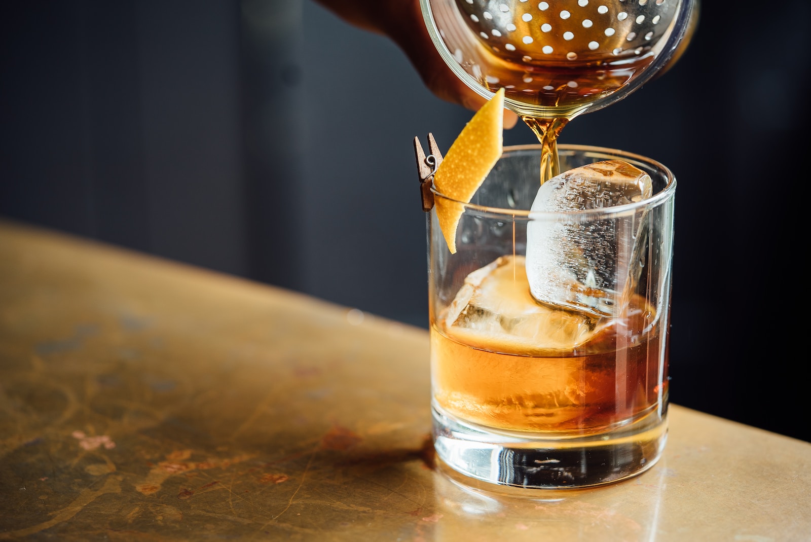 Manhattan liquor pouring on clear shot glass