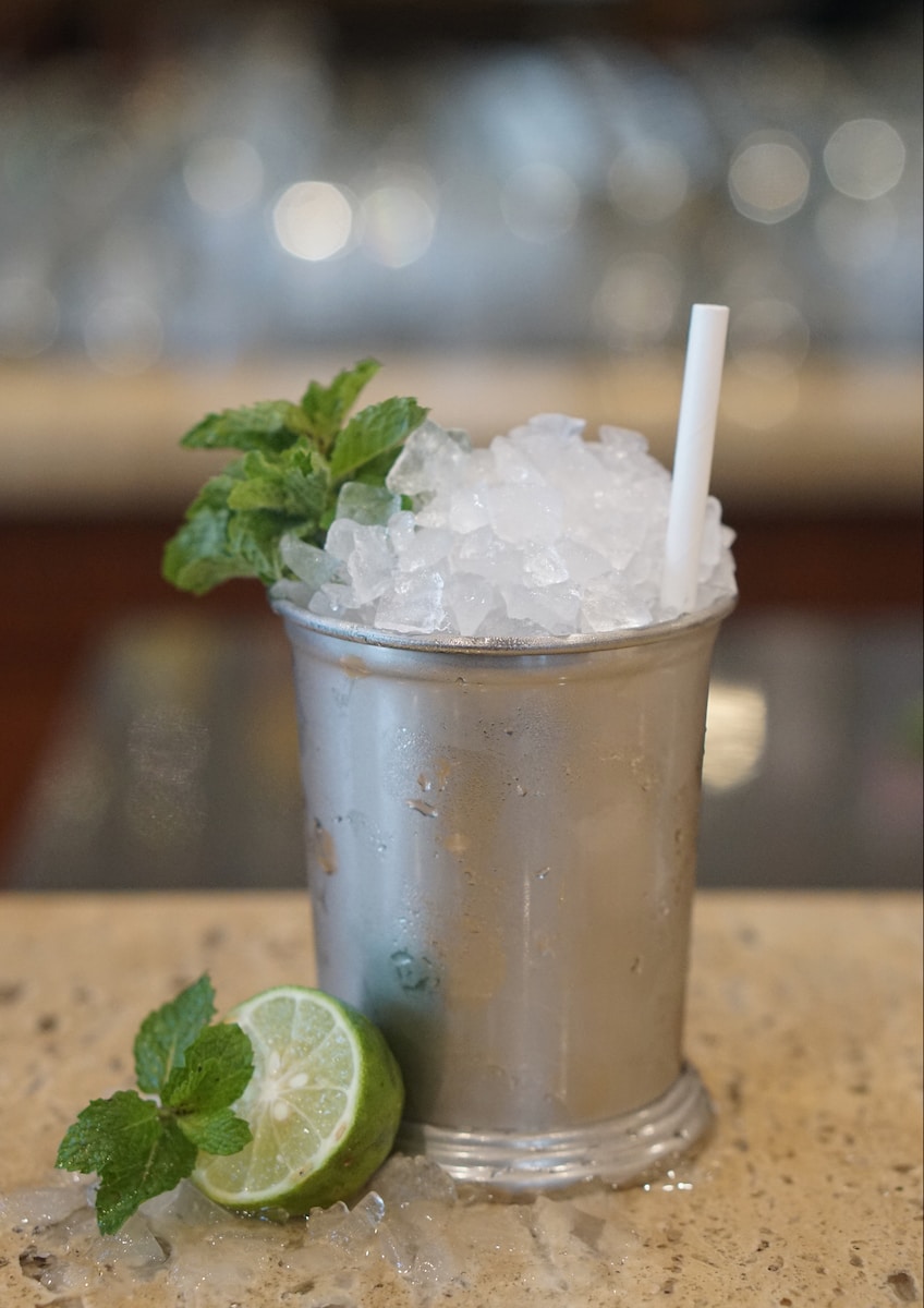 Mint Julep ice in clear plastic cup with straw