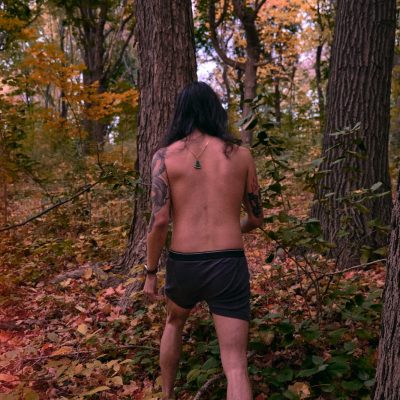 Boxer Shorts topless man in black shorts standing on forest during daytime