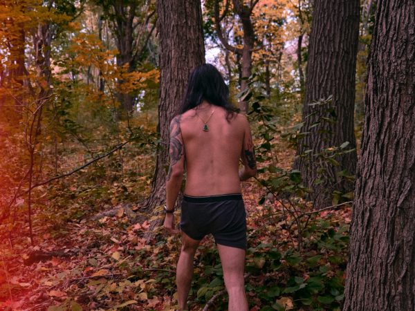 Boxer Shorts topless man in black shorts standing on forest during daytime